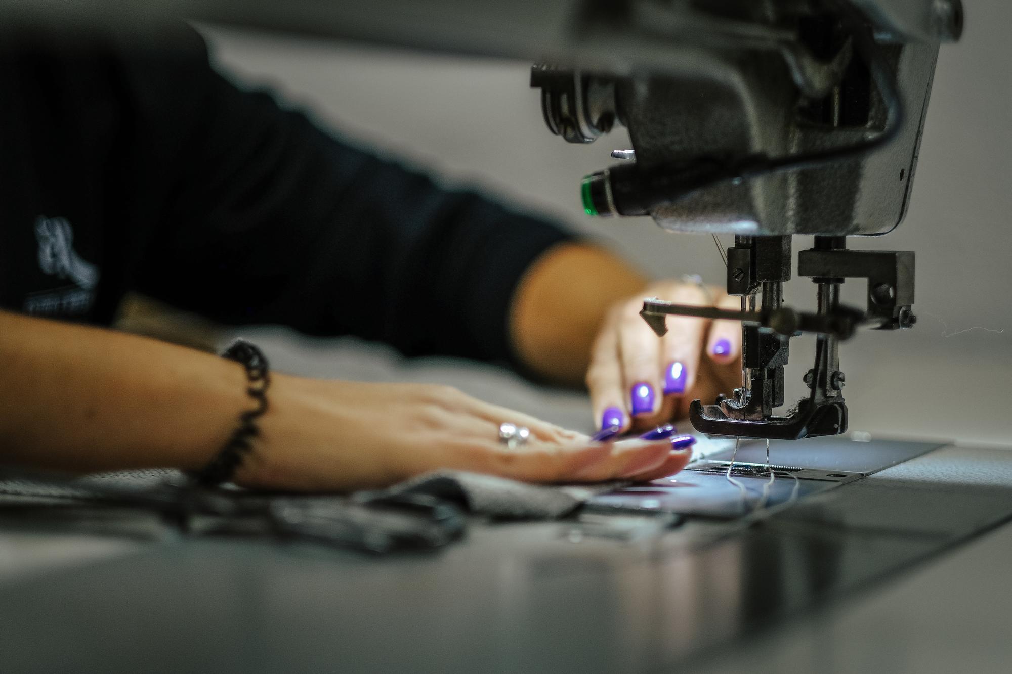 studio hands at embroidery machine